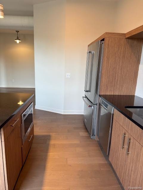804 N Main St Unit 2A, Rochester, MI 48307 - kitchen with stainless steel appliances, dark countertops, wood finished floors, and baseboards