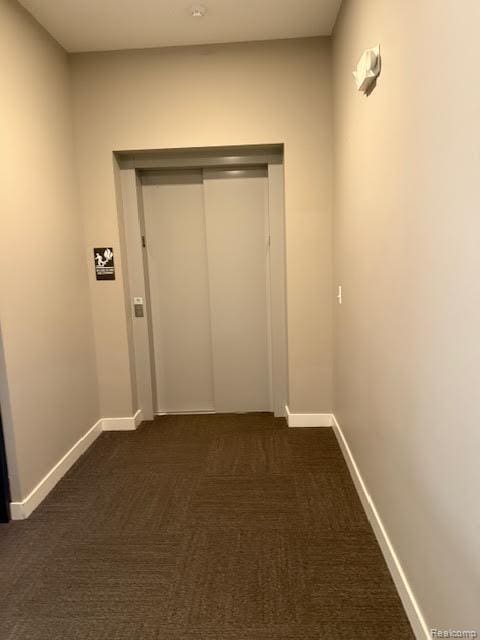 804 N Main St Unit 2A, Rochester, MI 48307 - corridor with dark colored carpet and baseboards