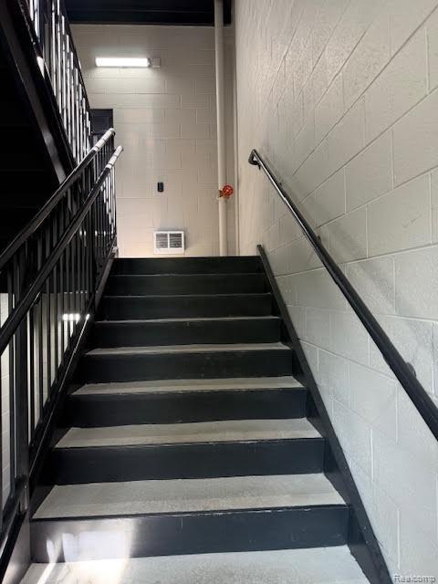 804 N Main St Unit 2A, Rochester, MI 48307 - stairs with concrete block wall