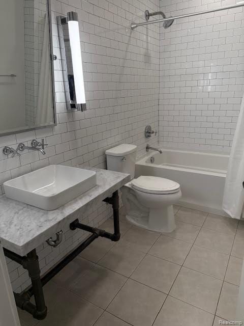 804 N Main St Unit 2A, Rochester, MI 48307 - full bathroom with tile patterned flooring, tile walls, shower / tub combo with curtain, a sink, and toilet