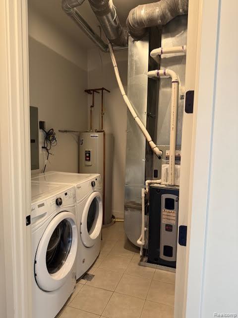 804 N Main St Unit 2A, Rochester, MI 48307 - washroom featuring water heater, light tile patterned floors, independent washer and dryer, electric panel, and heating unit
