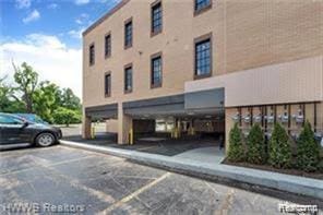 804 N Main St Unit 2A, Rochester, MI 48307 - view of building exterior featuring covered and uncovered parking
