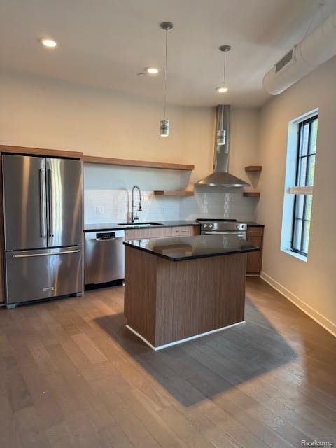 804 N Main St Unit 2A, Rochester, MI 48307 - kitchen featuring stainless steel appliances, exhaust hood, dark countertops, a sink, and a kitchen island