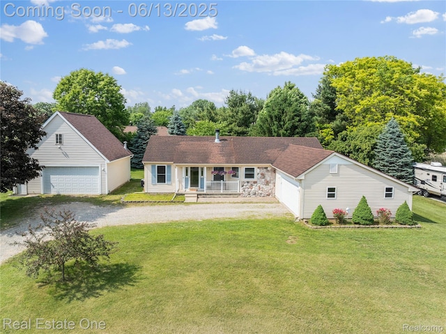 8907 Mccoll Side Rd, Brighton, MI 48116 - view of front of property with covered porch, a front yard, and a detached garage