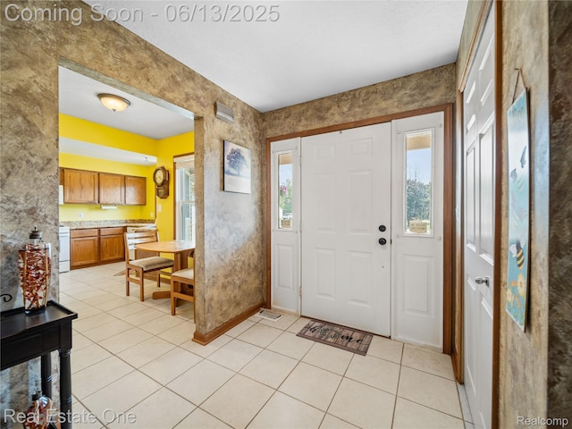 8907 Mccoll Side Rd, Brighton, MI 48116 - foyer featuring light tile patterned floors and baseboards