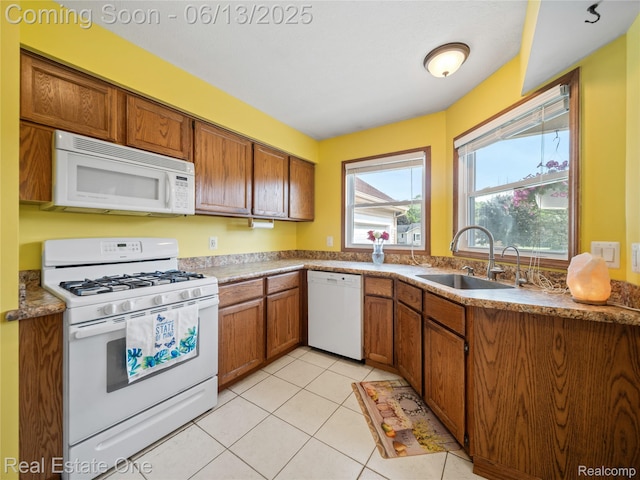 8907 Mccoll Side Rd, Brighton, MI 48116 - kitchen featuring white appliances, brown cabinetry, and light tile patterned floors