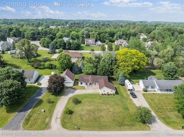 8907 Mccoll Side Rd, Brighton, MI 48116 - aerial perspective of suburban area with a heavily wooded area