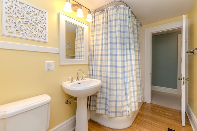 2430 Geddes Ave, Ann Arbor, MI 48104 - bathroom featuring toilet, wood finished floors, and curtained shower