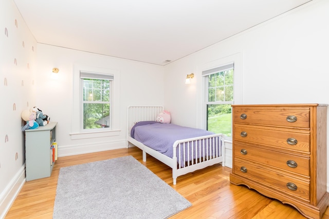 2430 Geddes Ave, Ann Arbor, MI 48104 - bedroom with multiple windows, light wood-type flooring, and baseboards