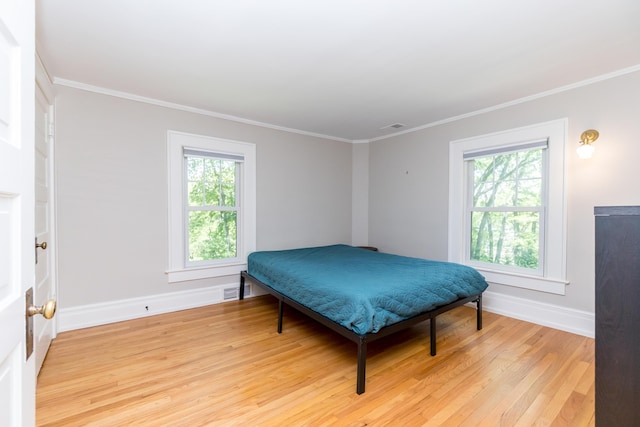 2430 Geddes Ave, Ann Arbor, MI 48104 - bedroom featuring multiple windows, light wood-style flooring, crown molding, and baseboards
