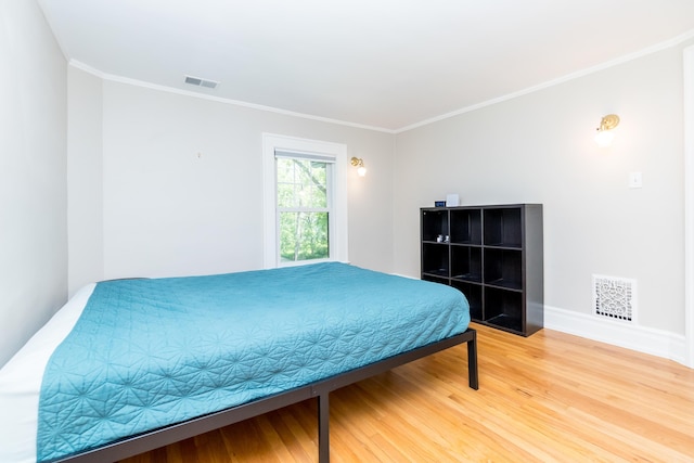 2430 Geddes Ave, Ann Arbor, MI 48104 - bedroom featuring light wood finished floors, crown molding, and baseboards