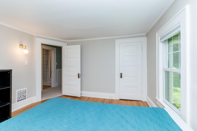 2430 Geddes Ave, Ann Arbor, MI 48104 - unfurnished bedroom featuring light wood-style floors, ornamental molding, and baseboards