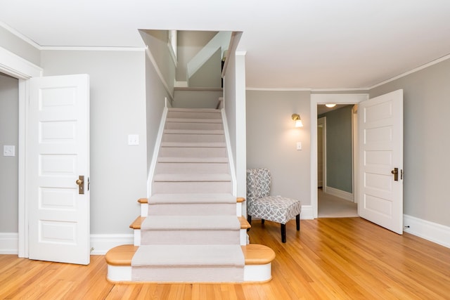 2430 Geddes Ave, Ann Arbor, MI 48104 - stairway featuring crown molding, wood finished floors, and baseboards