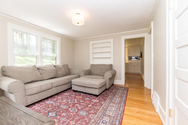2430 Geddes Ave, Ann Arbor, MI 48104 - living area with light wood finished floors, built in features, and ornamental molding