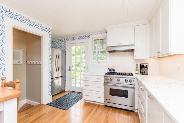 2430 Geddes Ave, Ann Arbor, MI 48104 - kitchen featuring stainless steel appliances, under cabinet range hood, white cabinetry, light wood finished floors, and backsplash