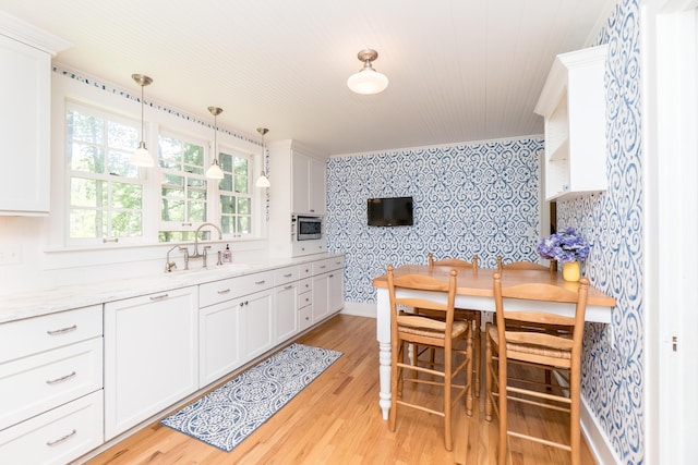 2430 Geddes Ave, Ann Arbor, MI 48104 - dining room with wallpapered walls, light wood-type flooring, wood ceiling, baseboards, and an accent wall