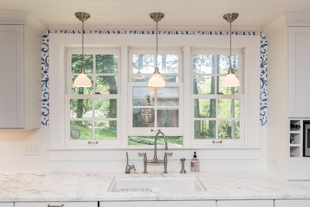 2430 Geddes Ave, Ann Arbor, MI 48104 - kitchen featuring a sink, hanging light fixtures, and light stone countertops