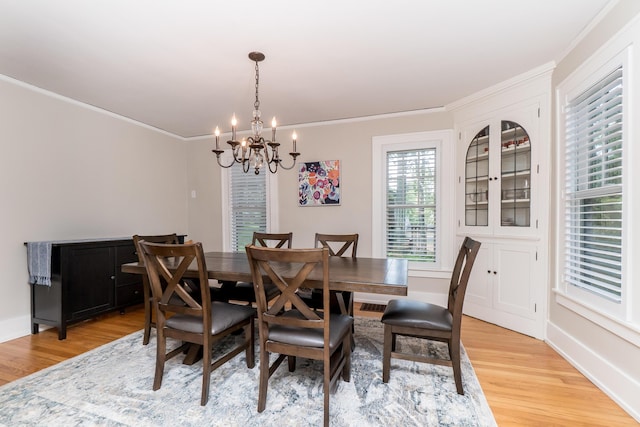 2430 Geddes Ave, Ann Arbor, MI 48104 - dining space featuring a chandelier, ornamental molding, light wood finished floors, and baseboards
