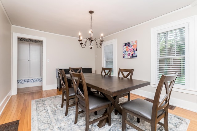 2430 Geddes Ave, Ann Arbor, MI 48104 - dining area featuring a chandelier, light wood-type flooring, ornamental molding, and baseboards