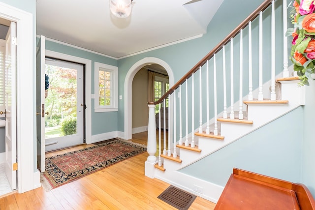 2430 Geddes Ave, Ann Arbor, MI 48104 - entrance foyer featuring wood finished floors, arched walkways, baseboards, stairs, and crown molding