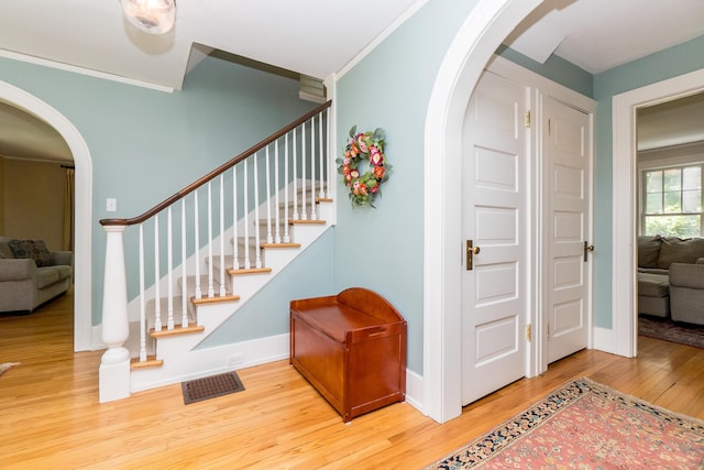2430 Geddes Ave, Ann Arbor, MI 48104 - stairway with arched walkways, wood finished floors, and ornamental molding