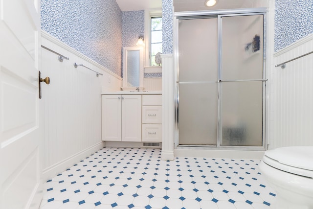 2430 Geddes Ave, Ann Arbor, MI 48104 - full bathroom featuring toilet, vanity, a stall shower, a wainscoted wall, and wallpapered walls