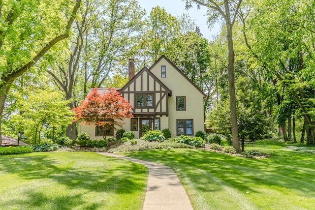 2430 Geddes Ave, Ann Arbor, MI 48104 - tudor home with stucco siding, a chimney, and a front lawn