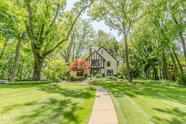 2430 Geddes Ave, Ann Arbor, MI 48104 - english style home featuring a chimney, a front yard, a balcony, and stucco siding
