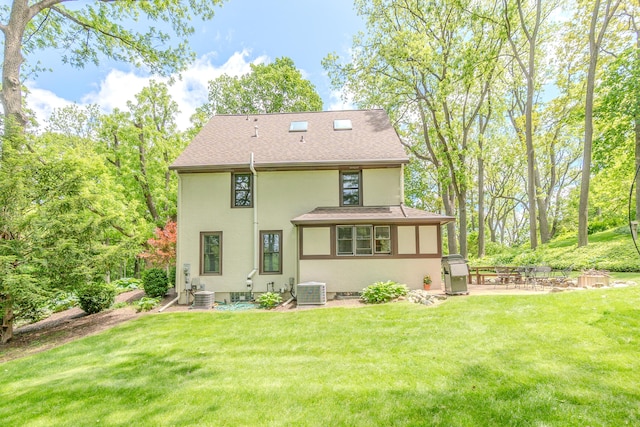 2430 Geddes Ave, Ann Arbor, MI 48104 - back of house featuring stucco siding, a patio area, a yard, and central AC