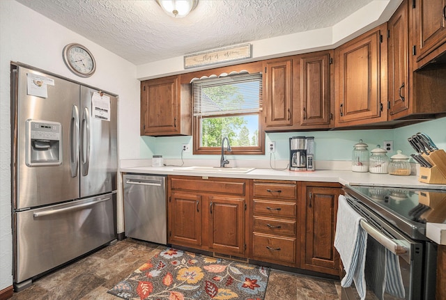 319 Washington St, Otsego, MI 49078 - kitchen with stainless steel appliances, a sink, stone finish flooring, light countertops, and a textured ceiling