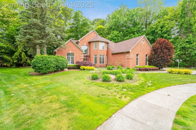 50565 Otter Creek Dr, Shelby Twp, MI 48317 - view of front of home with brick siding and a front yard