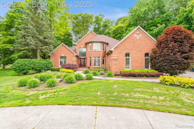 50565 Otter Creek Dr, Shelby Twp, MI 48317 - view of front of home featuring brick siding and a front yard