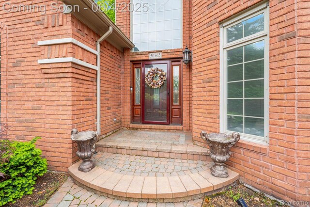 50565 Otter Creek Dr, Shelby Twp, MI 48317 - view of exterior entry featuring brick siding