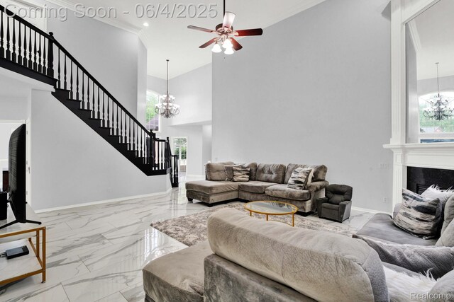 50565 Otter Creek Dr, Shelby Twp, MI 48317 - living area with baseboards, marble finish flooring, stairs, a chandelier, and a towering ceiling