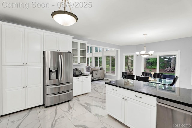 50565 Otter Creek Dr, Shelby Twp, MI 48317 - kitchen with appliances with stainless steel finishes, light marble finish flooring, a chandelier, white cabinetry, and glass insert cabinets