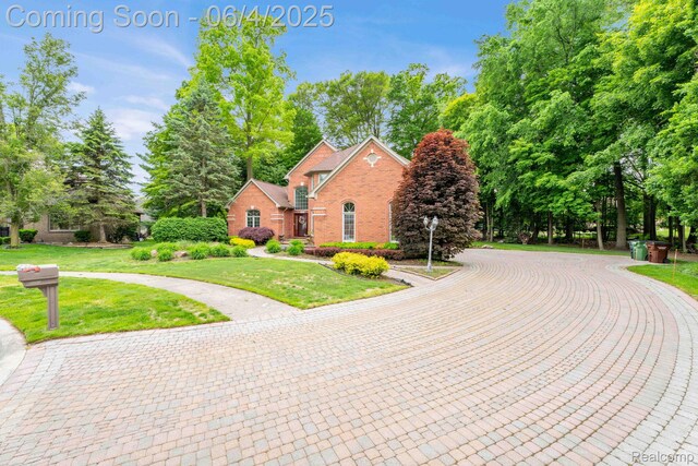 50565 Otter Creek Dr, Shelby Twp, MI 48317 - view of front of property with brick siding and a front yard