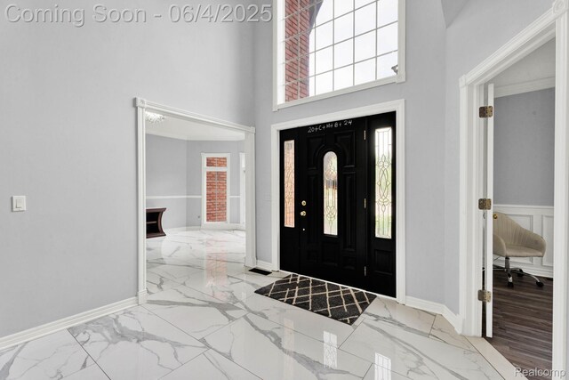 50565 Otter Creek Dr, Shelby Twp, MI 48317 - entryway with marble tiled floors, a towering ceiling, healthy amount of natural light, and baseboards