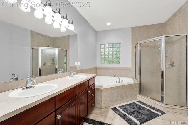 50565 Otter Creek Dr, Shelby Twp, MI 48317 - bathroom featuring tile patterned floors, double vanity, a garden tub, and a stall shower