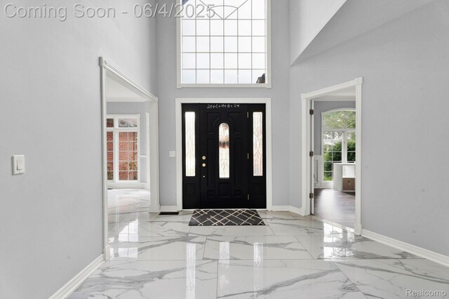 50565 Otter Creek Dr, Shelby Twp, MI 48317 - entryway with marble tiled flooring, a towering ceiling, and baseboards
