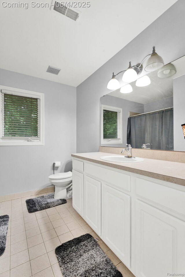 50565 Otter Creek Dr, Shelby Twp, MI 48317 - bathroom with tile patterned flooring, toilet, vanity, a shower with shower curtain, and healthy amount of natural light