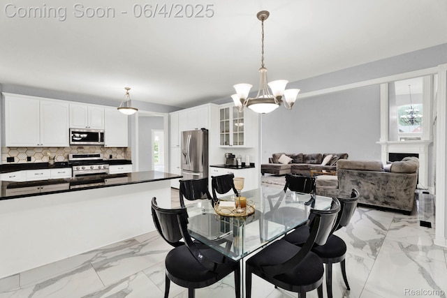 50565 Otter Creek Dr, Shelby Twp, MI 48317 - dining area featuring a chandelier and light marble finish floors