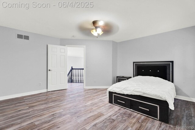 50565 Otter Creek Dr, Shelby Twp, MI 48317 - bedroom with wood finished floors, baseboards, and a ceiling fan