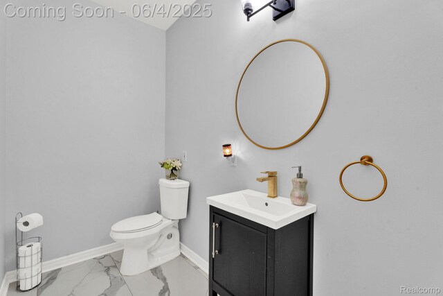 50565 Otter Creek Dr, Shelby Twp, MI 48317 - half bath with vanity, baseboards, marble look tile flooring, and toilet