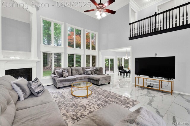 50565 Otter Creek Dr, Shelby Twp, MI 48317 - living area with ornamental molding, a towering ceiling, ceiling fan, marble finish flooring, and baseboards