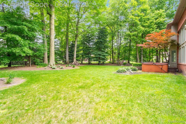 50565 Otter Creek Dr, Shelby Twp, MI 48317 - view of green lawn featuring a hot tub