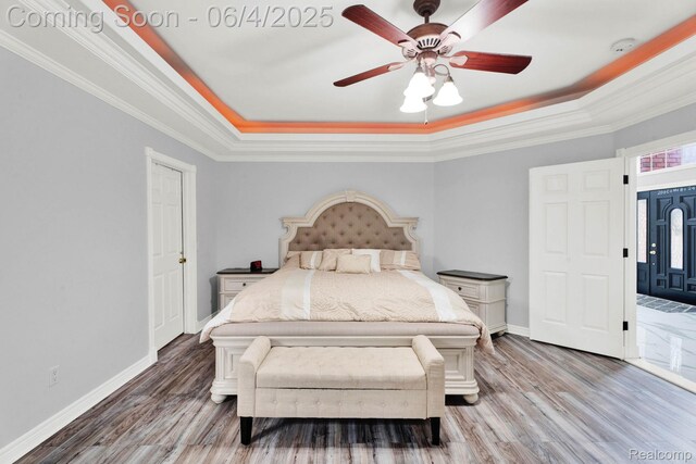 50565 Otter Creek Dr, Shelby Twp, MI 48317 - bedroom featuring a raised ceiling, baseboards, light wood-style flooring, crown molding, and ceiling fan