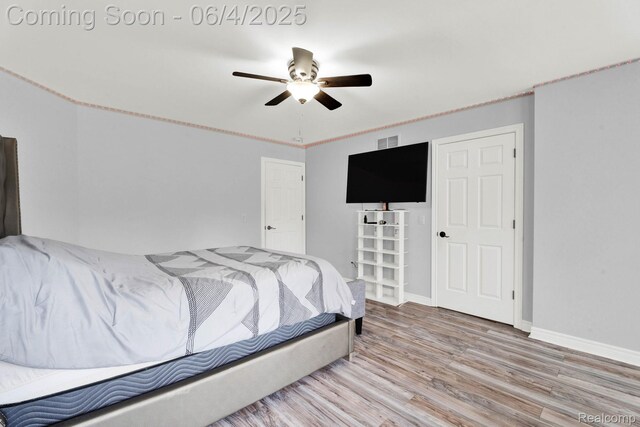 50565 Otter Creek Dr, Shelby Twp, MI 48317 - bedroom featuring wood finished floors, baseboards, and a ceiling fan