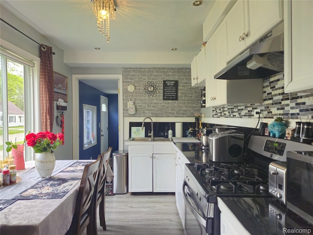 22189 Albion Ave, Farmington Hills, MI 48336 - kitchen with stainless steel appliances, under cabinet range hood, decorative backsplash, and white cabinetry