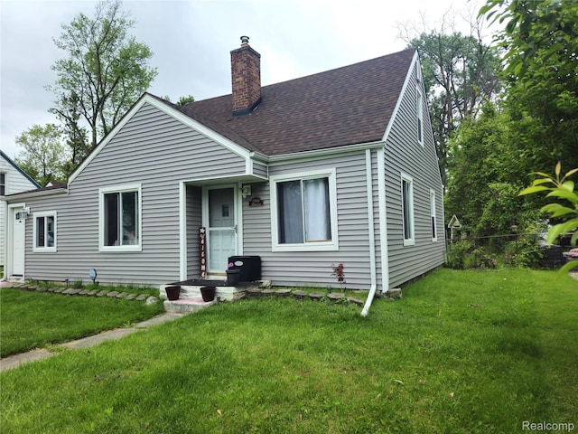 22189 Albion Ave, Farmington Hills, MI 48336 - view of front of house with a chimney, roof with shingles, and a front lawn