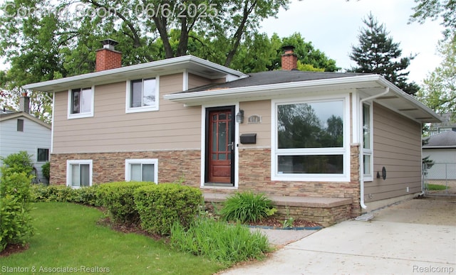 608 Woodlawn Ave, Royal Oak, MI 48073 - split level home featuring a chimney and stone siding